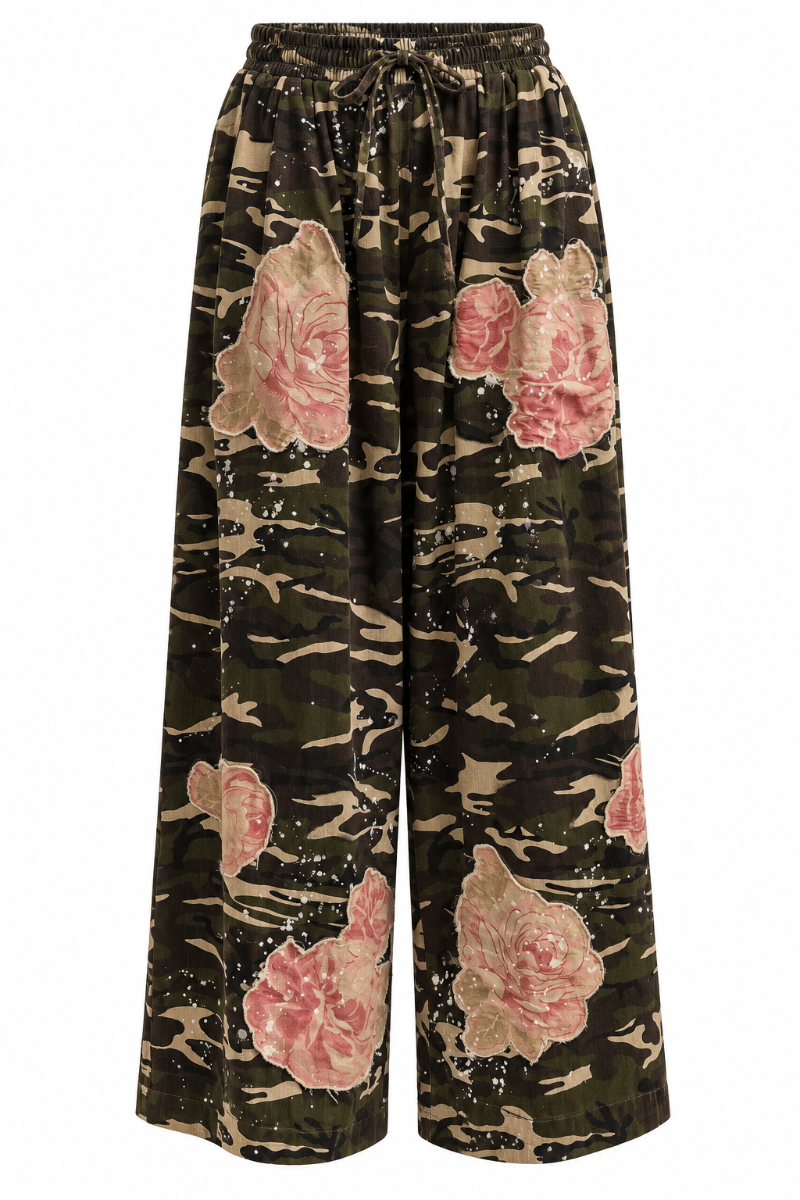 Trestles Clothing Company wide leg camo pants with pink rose floral patches, paint splatters, and elastic tie waist.